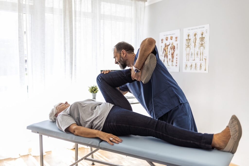 Chiropractor helping an old patient